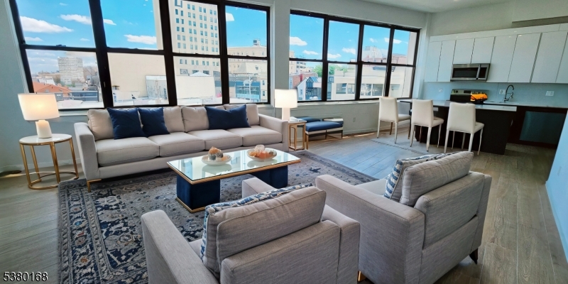 30 Howe Avenue, Unit 304 Passaic, NJ 07055 - Photo 1 of 12 a living room with furniture and a large window