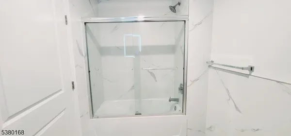 a bathroom with a glass shower door