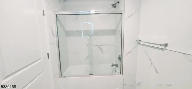 a bathroom with a glass shower door