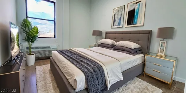 a bedroom with a bed and wooden floor