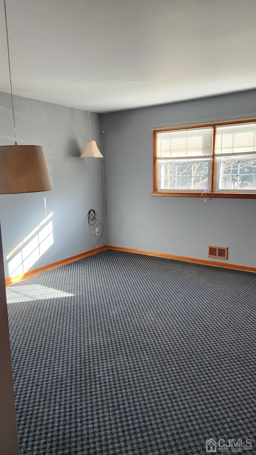 20 Middlesex Avenue Edison, NJ 08820 - Photo 14 of 28 a view of an empty room with wooden floor and a window