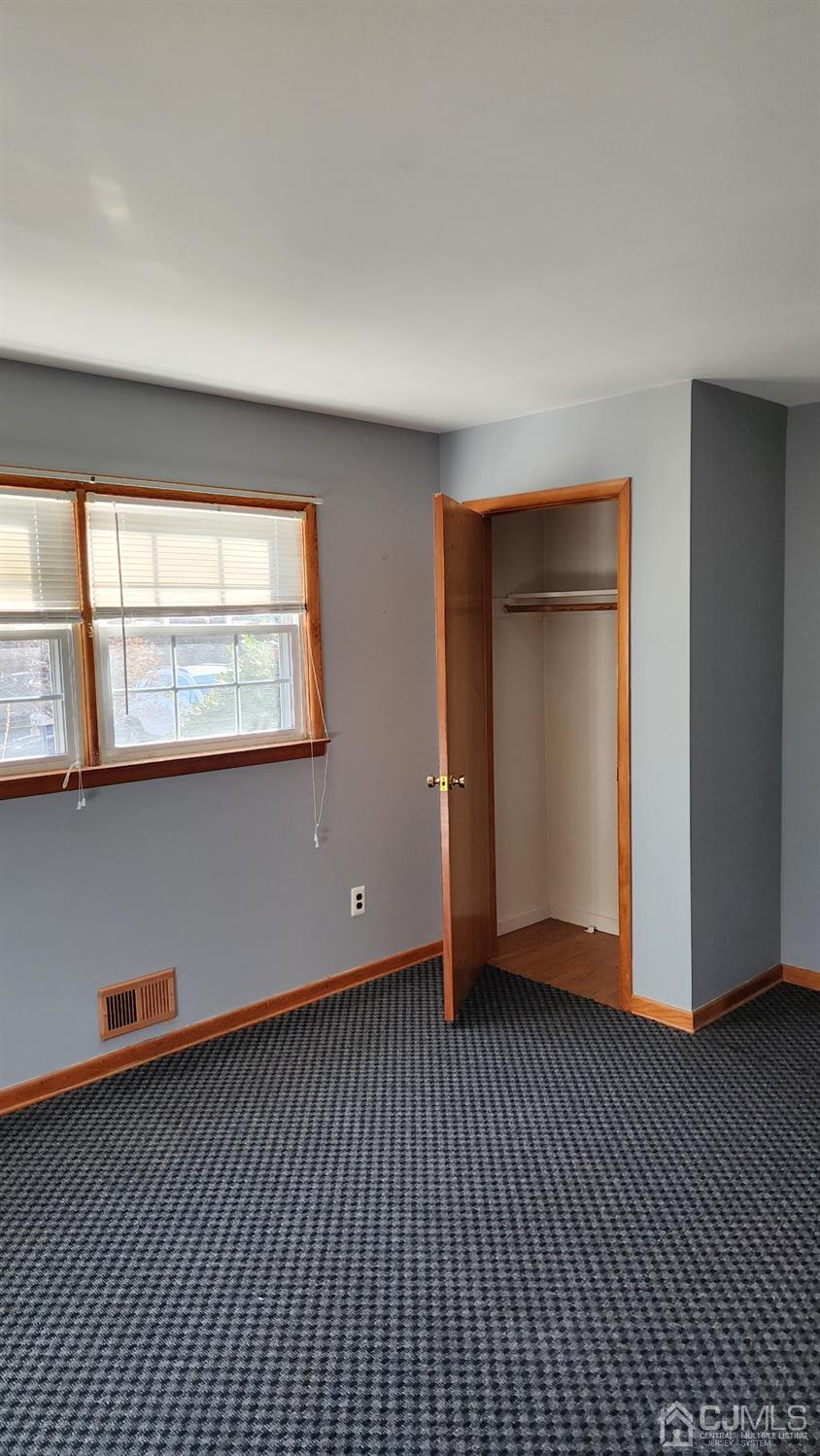 20 Middlesex Avenue Edison, NJ 08820 - Photo 15 of 28 a view of an empty room with wooden floor and a window