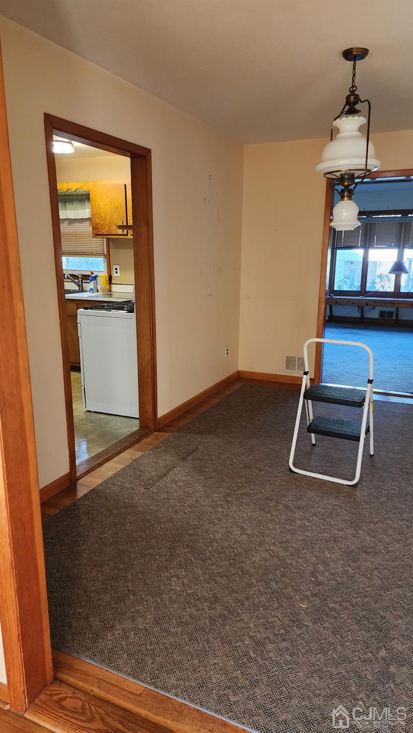 20 Middlesex Avenue Edison, NJ 08820 - Photo 19 of 28 an empty room with wooden floor and windows