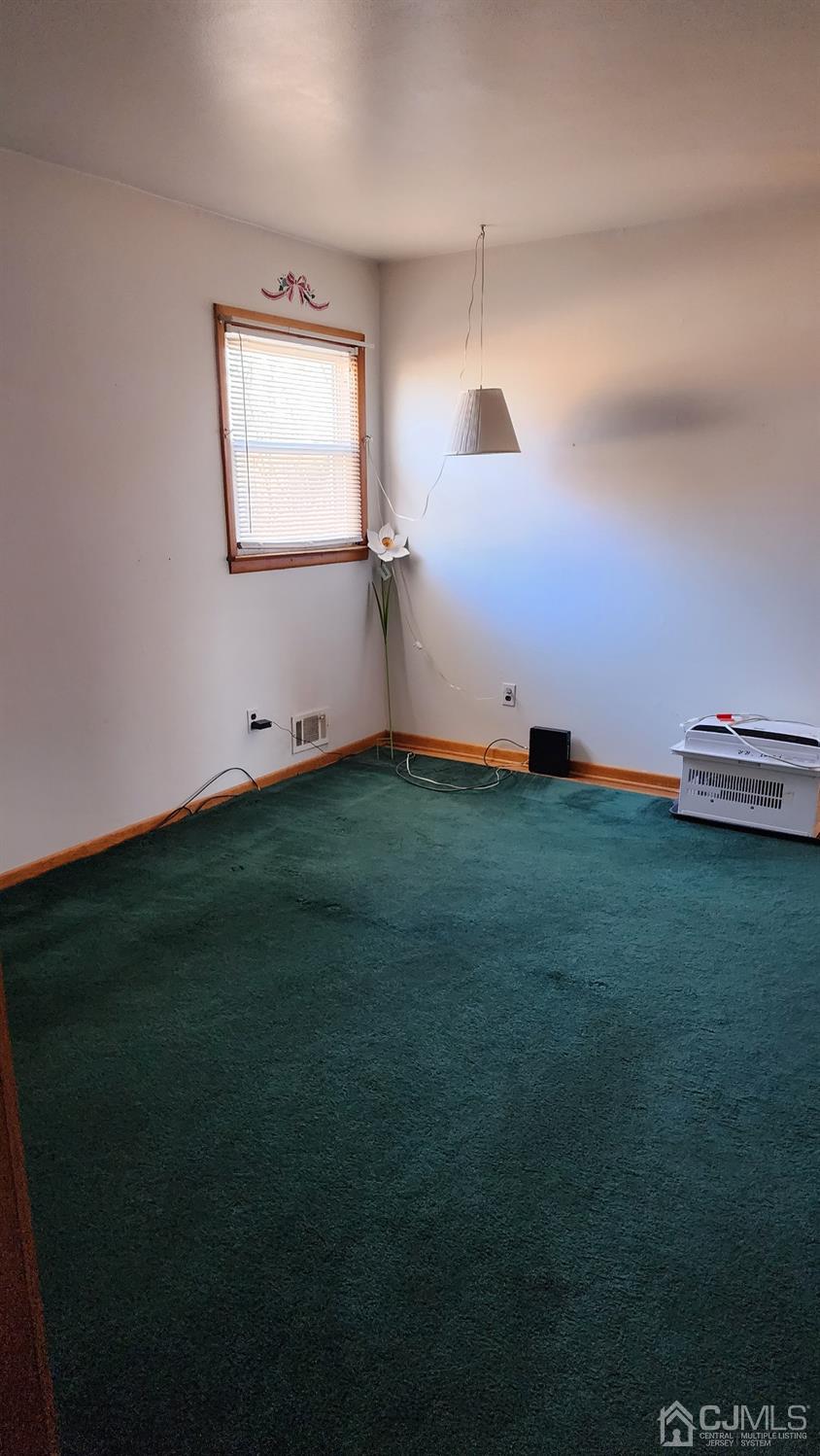 20 Middlesex Avenue Edison, NJ 08820 - Photo 10 of 28 a view of an empty room with window and a fireplace