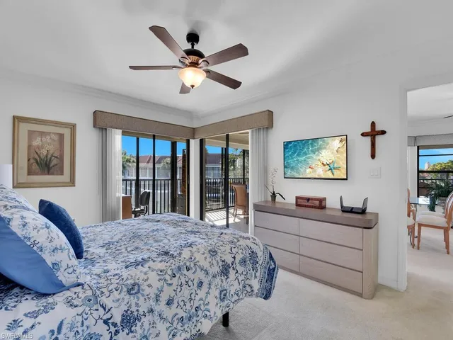 a bedroom with a large bed and a flat screen tv