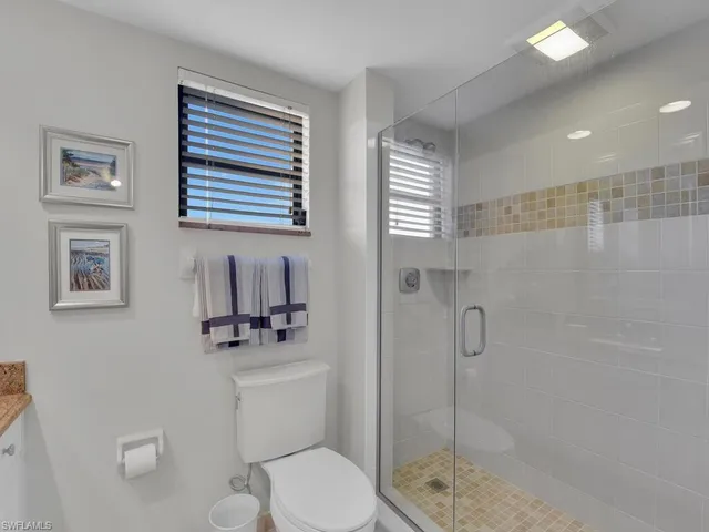 a bathroom with a toilet a sink and a shower