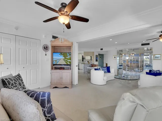 a living room with furniture and kitchen view