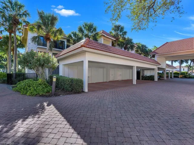 a view of a house with a yard and potted plants