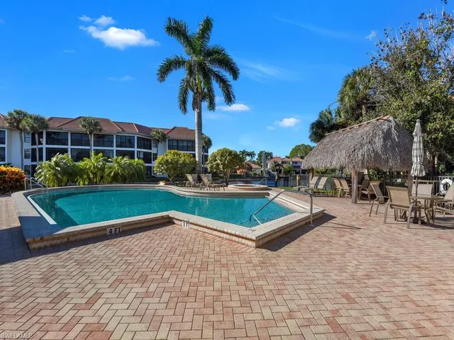 a view of swimming pool with outdoor seating and yard