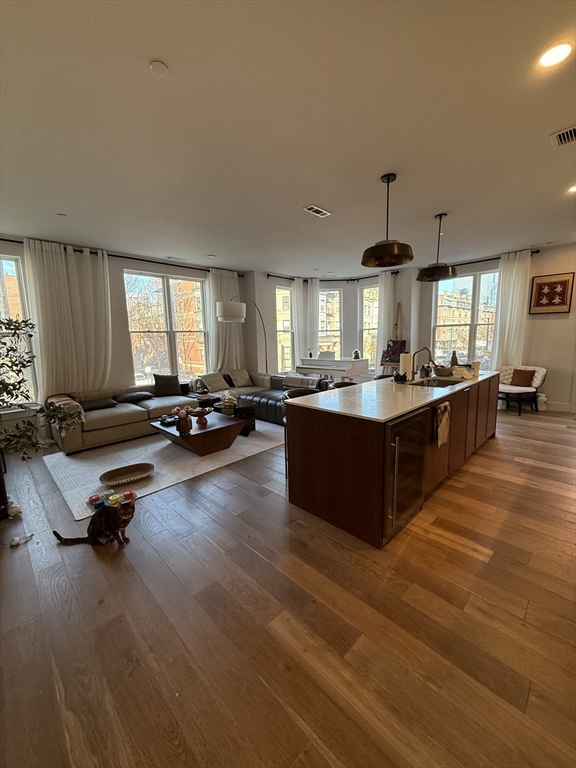 566 Columbus Avenue, Unit 211 Boston, MA 02118 - Photo 1 of 42 a large kitchen with a large counter top furniture a sink and a chandelier