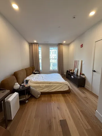 a spacious bedroom with a bed and a couch