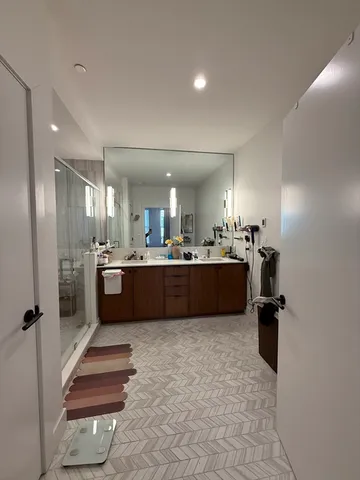 a large bathroom with a tub a sink a mirror and a shower