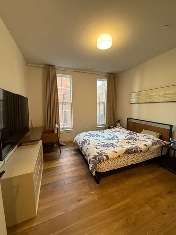 a bedroom with a bed and a flat screen tv