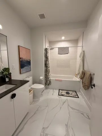 a bathroom with a sink a toilet and mirror