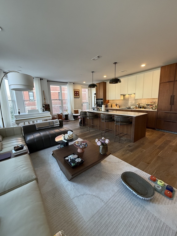 566 Columbus Avenue, Unit 211 Boston, MA 02118 - Photo 2 of 42 a living room with furniture and a wooden floor