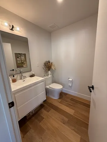 a bathroom with a sink toilet and a mirror
