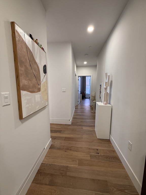 566 Columbus Avenue, Unit 211 Boston, MA 02118 - Photo 25 of 42 a view of a hallway with wooden floor and staircase