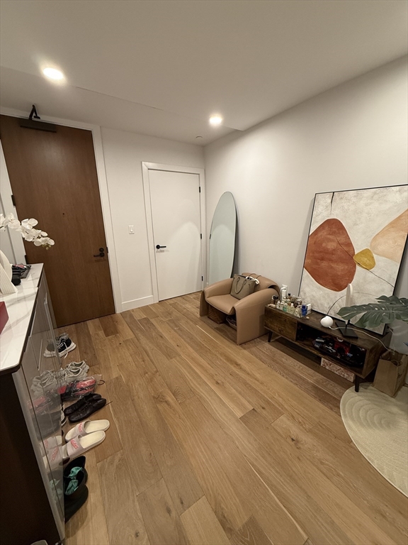 566 Columbus Avenue, Unit 211 Boston, MA 02118 - Photo 26 of 42 a bedroom with bed and wooden floor