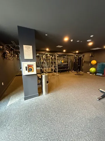 a view of a room with gym equipment and a large window