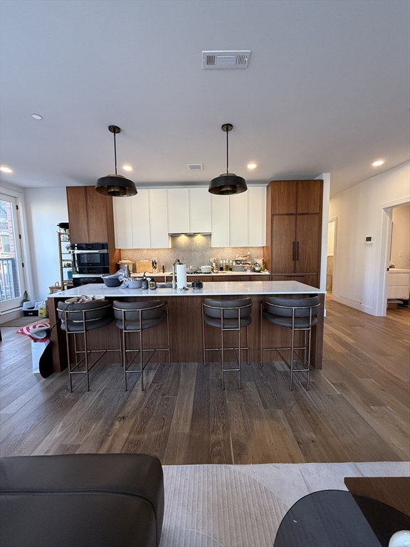 566 Columbus Avenue, Unit 211 Boston, MA 02118 - Photo 6 of 42 a living room with stainless steel appliances kitchen island granite countertop furniture and wooden floors