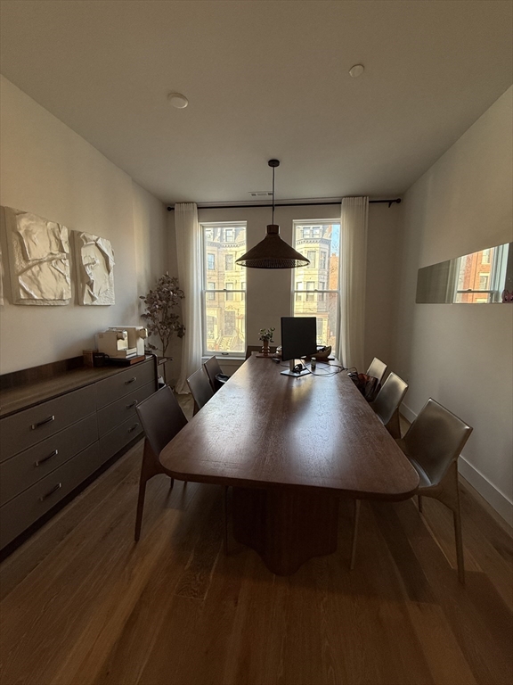 566 Columbus Avenue, Unit 211 Boston, MA 02118 - Photo 9 of 42 a view of a dining room with furniture window and wooden floor