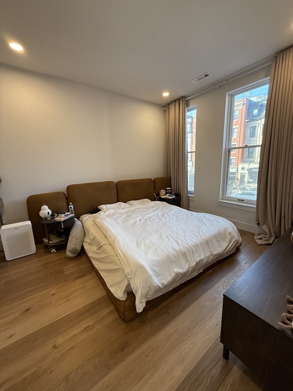 566 Columbus Avenue, Unit 211 Boston, MA 02118 - Photo 10 of 42 a bedroom with a bed and wooden floor