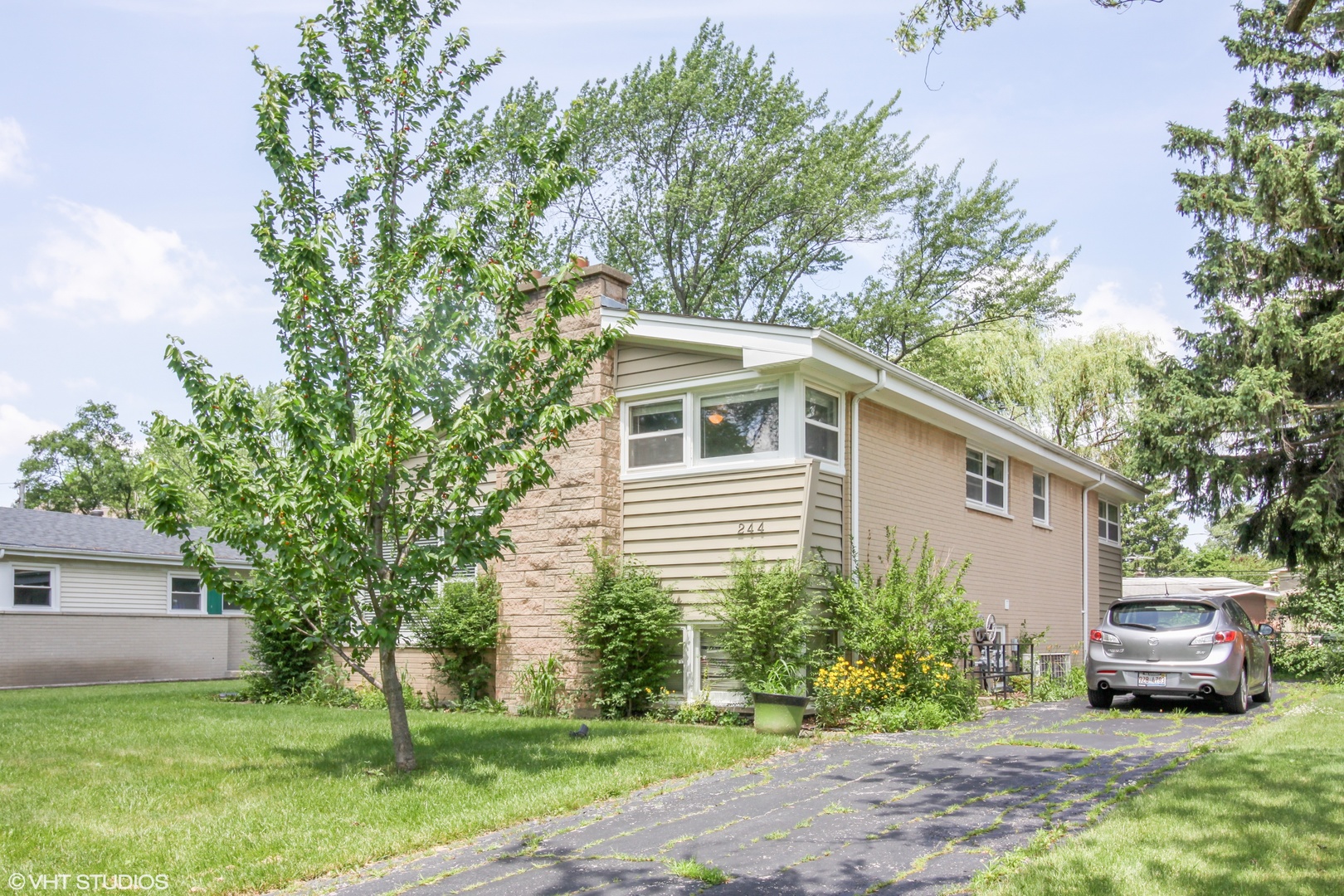 244 Glendale Road Glenview, IL 60025 - Photo 19 of 25 a front view of a house with a garden and trees