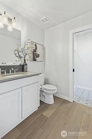 a bathroom with a toilet sink and mirror