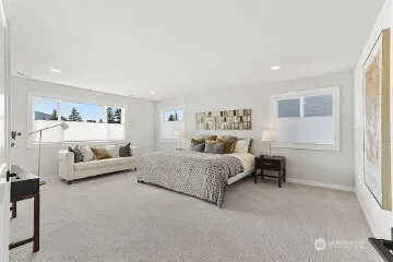 a spacious bedroom with a bed and a couch