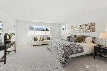 a spacious bedroom with a bed and a couch
