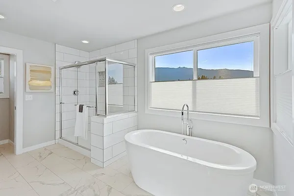 a white bath tub sitting next to a shower