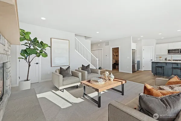 a living room with furniture and a potted plant