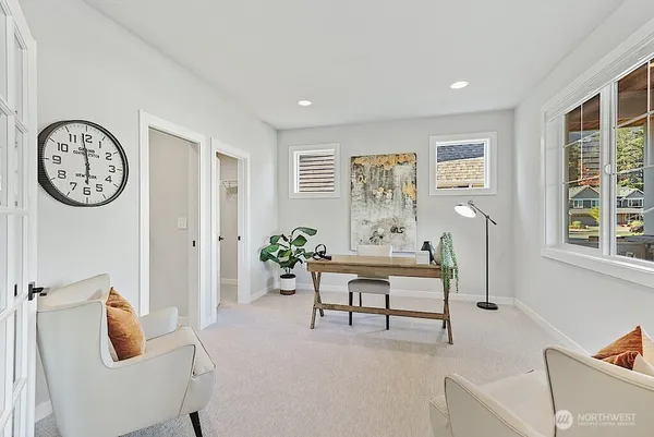 a living room with furniture and a clock