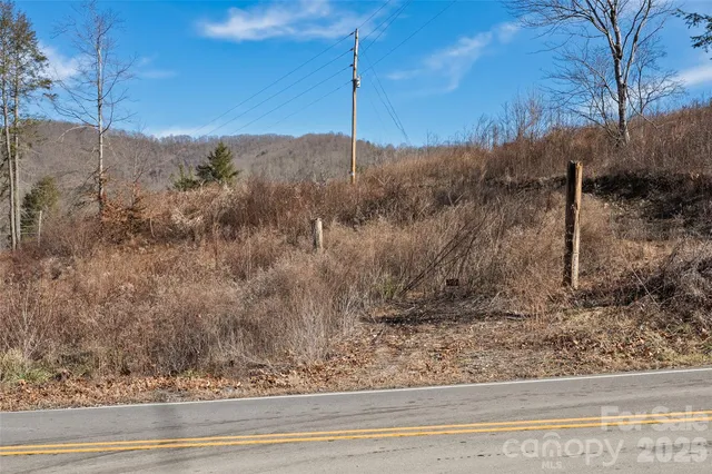 a view of a dry yard with mountains in the background
