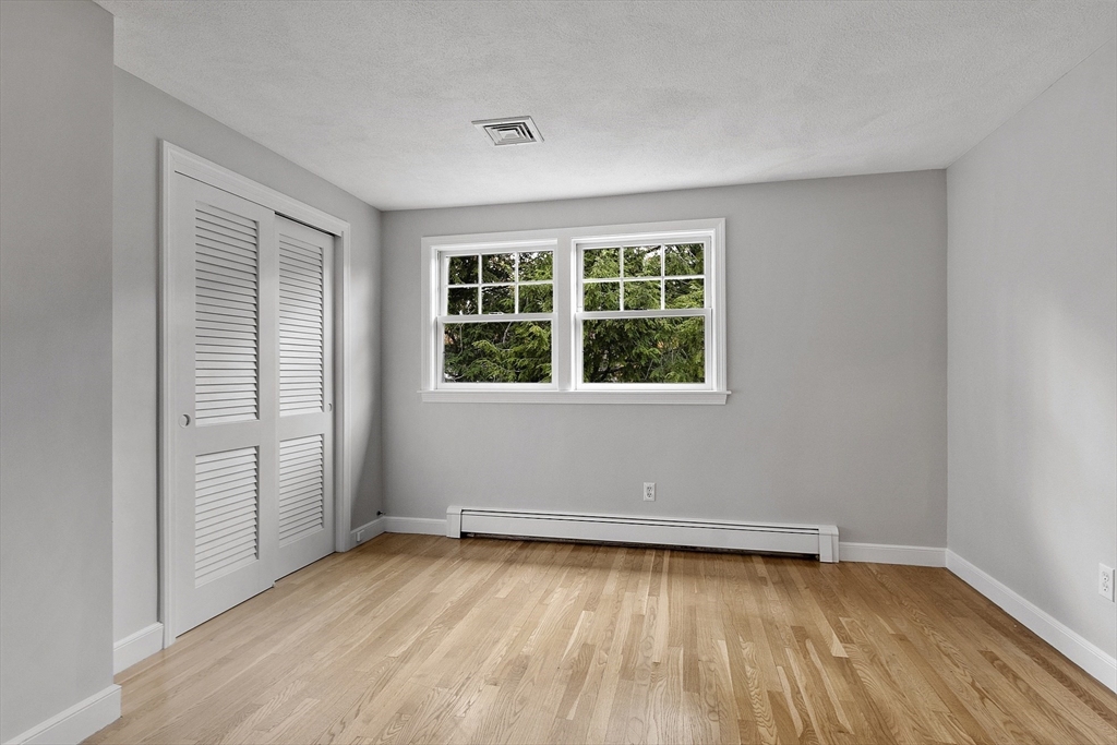 80 North Branch Road Concord, MA 01742 - Photo 21 of 35 an empty room with wooden floor and windows