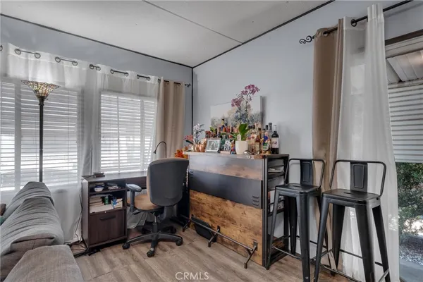a view of a workspace with furniture and a window