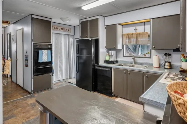 a kitchen with a refrigerator and a sink