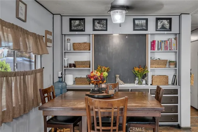 a view of a dining room with furniture and a potted plant