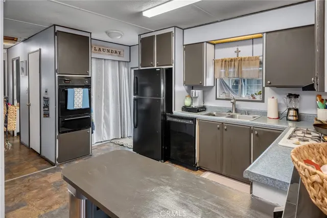 a kitchen with a refrigerator and a sink