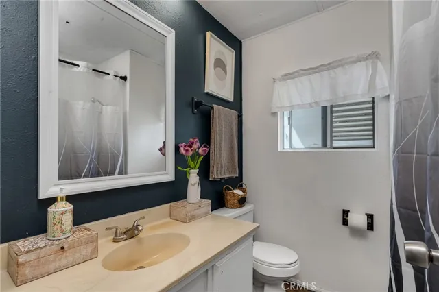 a bathroom with a sink toilet and mirror