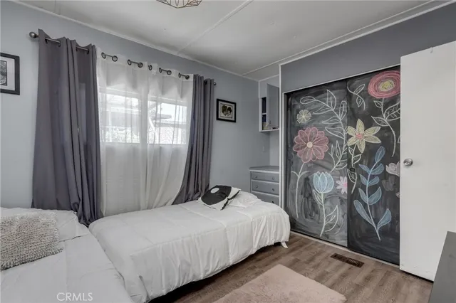 a bedroom with a large bed and a window