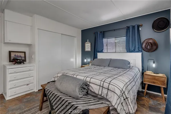 a bedroom with a bed and cabinets