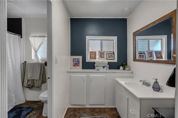 a bathroom with a sink toilet and mirror