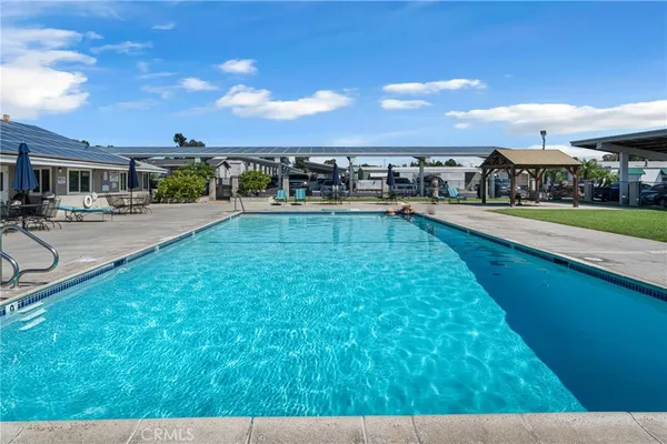 a view of a swimming pool with outdoor seating