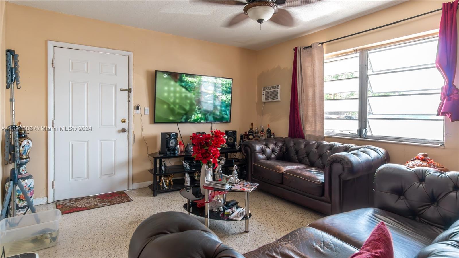 23 West 13th Street Hialeah, FL 33010 - Photo 21 of 54 a living room with furniture and a flat screen tv