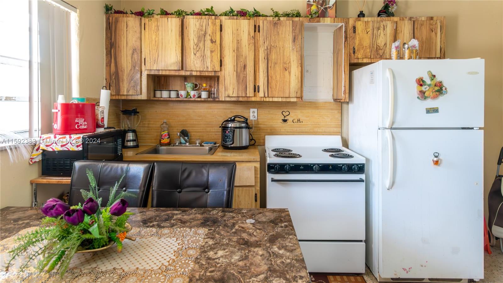 23 West 13th Street Hialeah, FL 33010 - Photo 23 of 54 a kitchen with a refrigerator and a stove