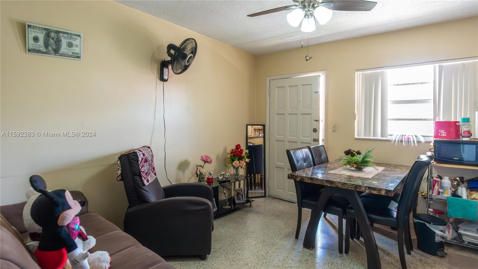 23 West 13th Street Hialeah, FL 33010 - Photo 24 of 54 a living room with furniture and a chandelier
