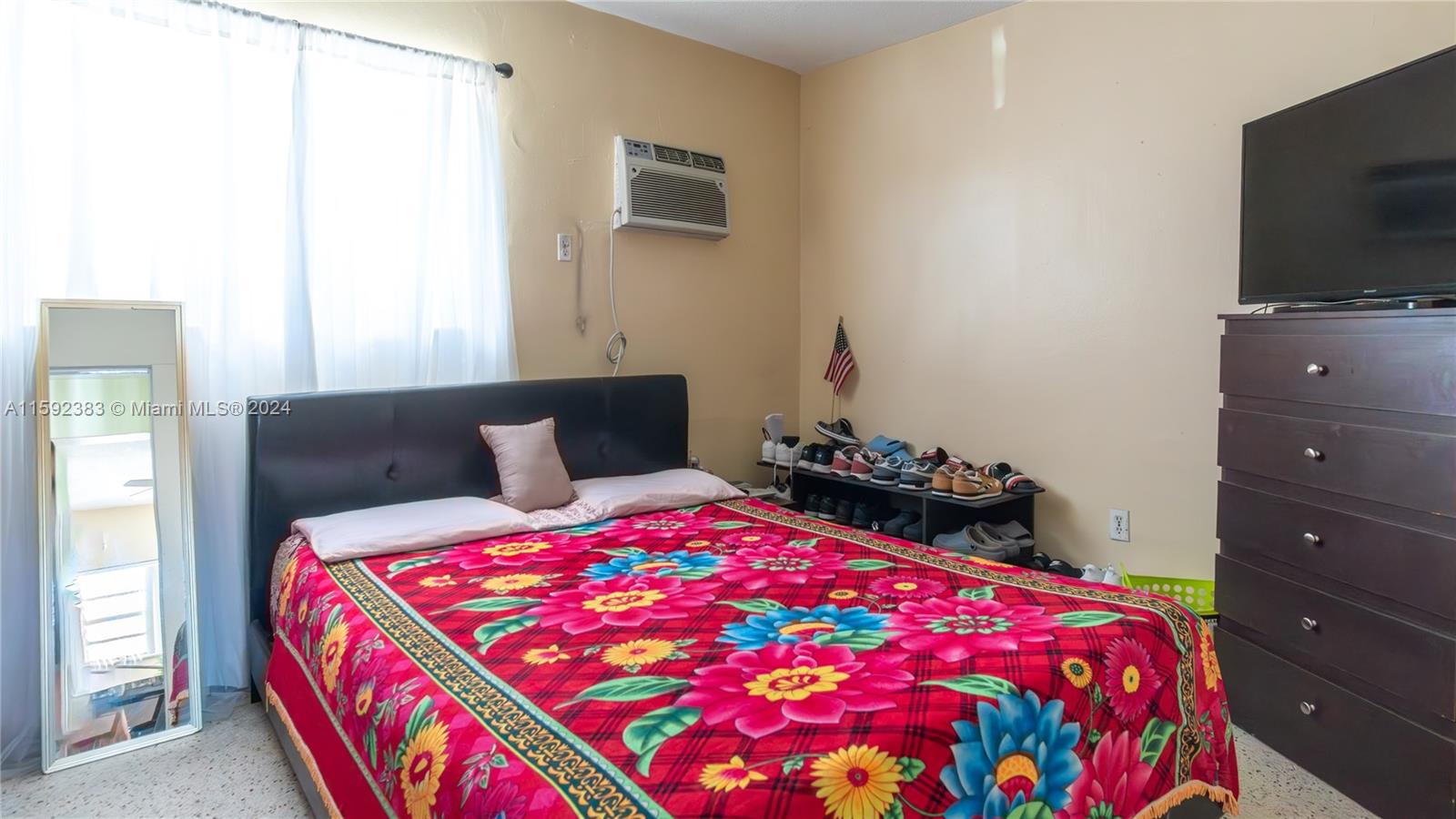 23 West 13th Street Hialeah, FL 33010 - Photo 27 of 54 a bedroom with a bed and flat screen tv