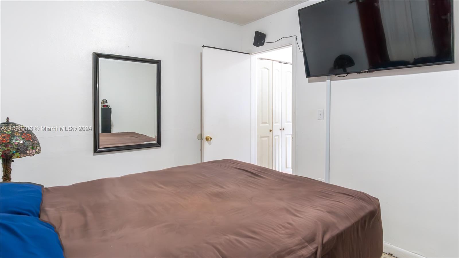 23 West 13th Street Hialeah, FL 33010 - Photo 37 of 54 a bedroom with a bed and a window