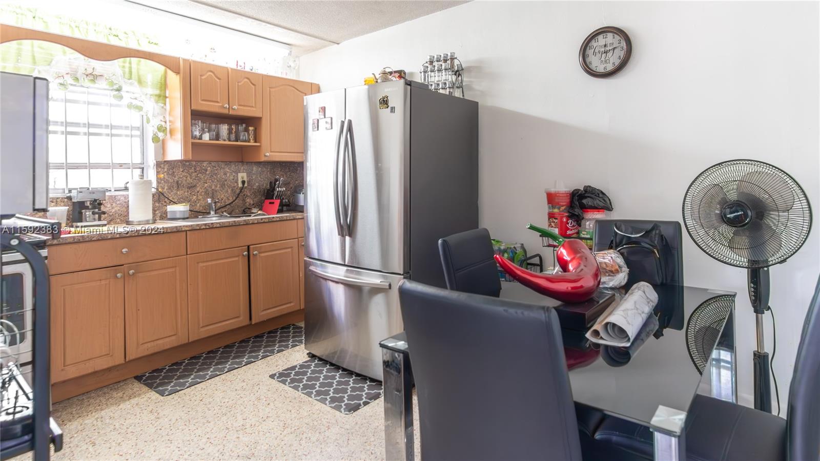 23 West 13th Street Hialeah, FL 33010 - Photo 43 of 54 a kitchen with stainless steel appliances granite countertop a sink refrigerator and cabinets